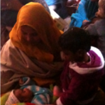 Mother with baby and child in India